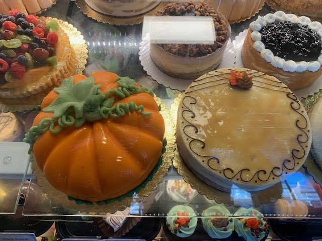 Primrose Bakery, located in Downtown Pleasanton, showcases new fall designs like frosted pumpkins and caramel maple leaves in their chilled section, known for their unique, beautifully crafted cakes.