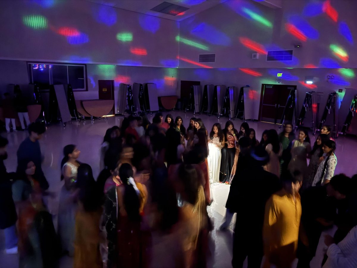 Members from the Indian Culture Club (ICC) dance on the stage. 