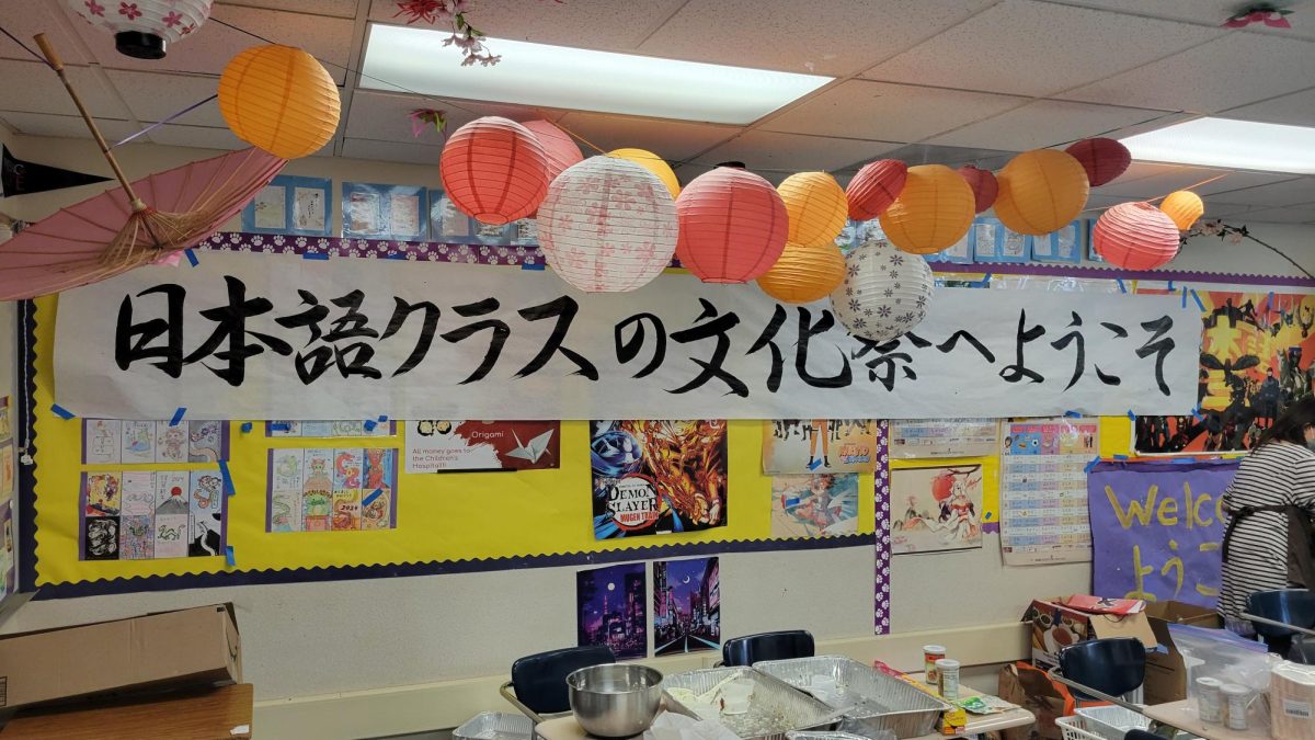 The Japanese Class prepares a sign for the upcoming Fall Festival.