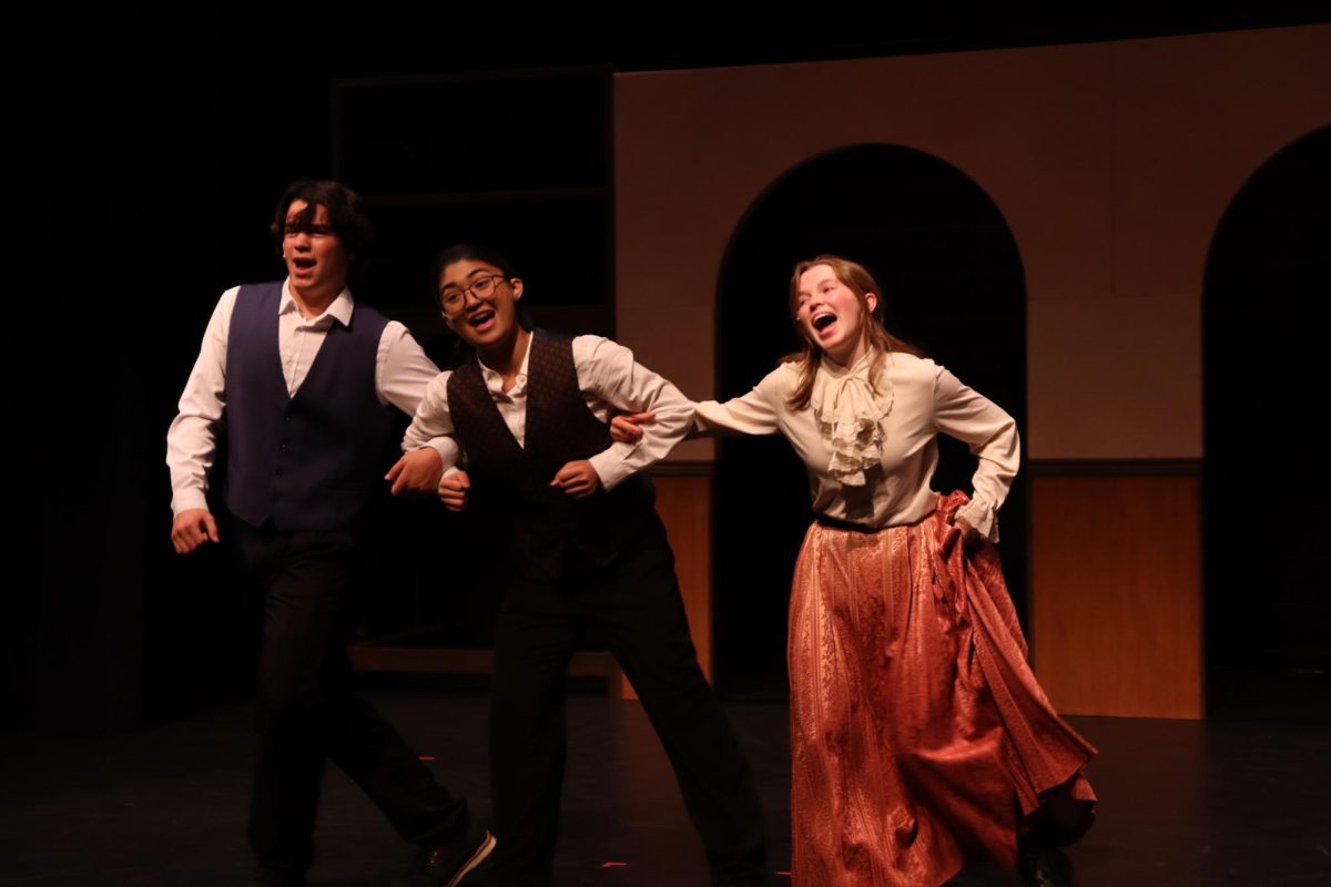 Logan Jew-Fortner ('27) playing Dimitry, Sophia Garcia ('25) playing Vlad Popov, and Makenna Faddis (Foothill '25) playing Anya/Anastasia take over the stage in the musical number of Learn To Do It where Dimitri and Vlad attempt to teach Anya how to act as the Grand Duchess Anastasia.