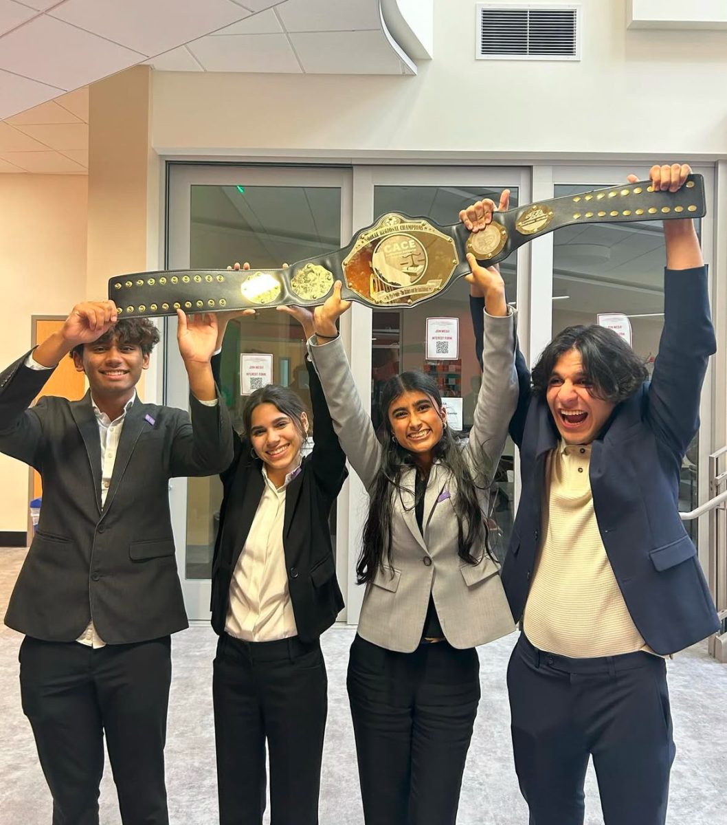 Unit 3 holds up the regionals belt trophy.