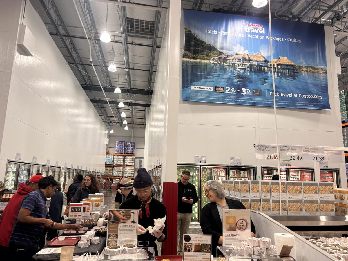 At this sample station, employees hand out different kinds of cheeses.