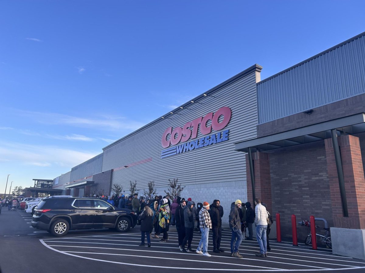 Wrapped along the whole Costco building, customers chatter amongst each other about entering the new refurbishment.