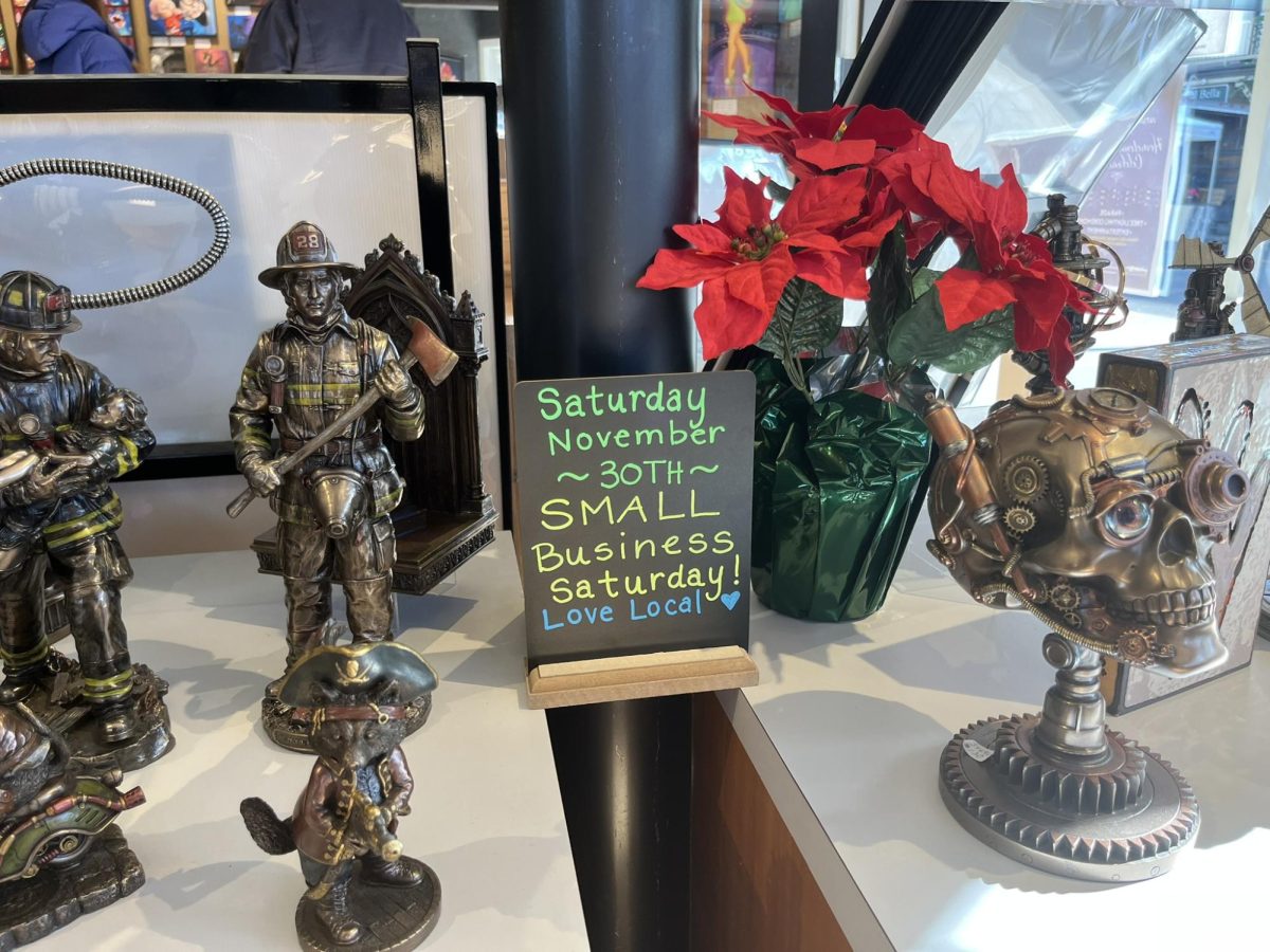 Signs for Small Business Saturday are nestled between sculptures throughout the Studio Seven Art Studio.