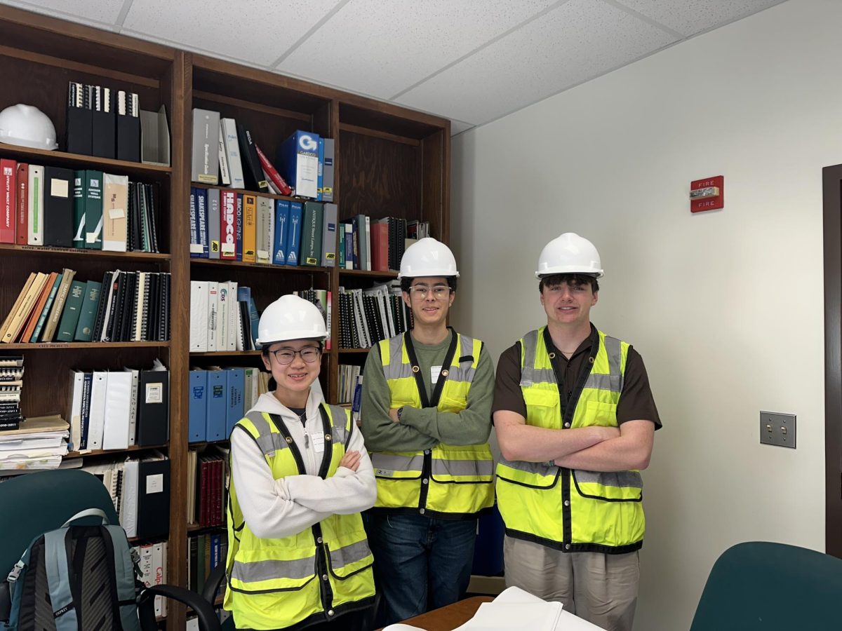 While shadowing the Public Works department, students gear up with helmets and high visibility clothing for a visit to an ongoing construction project.