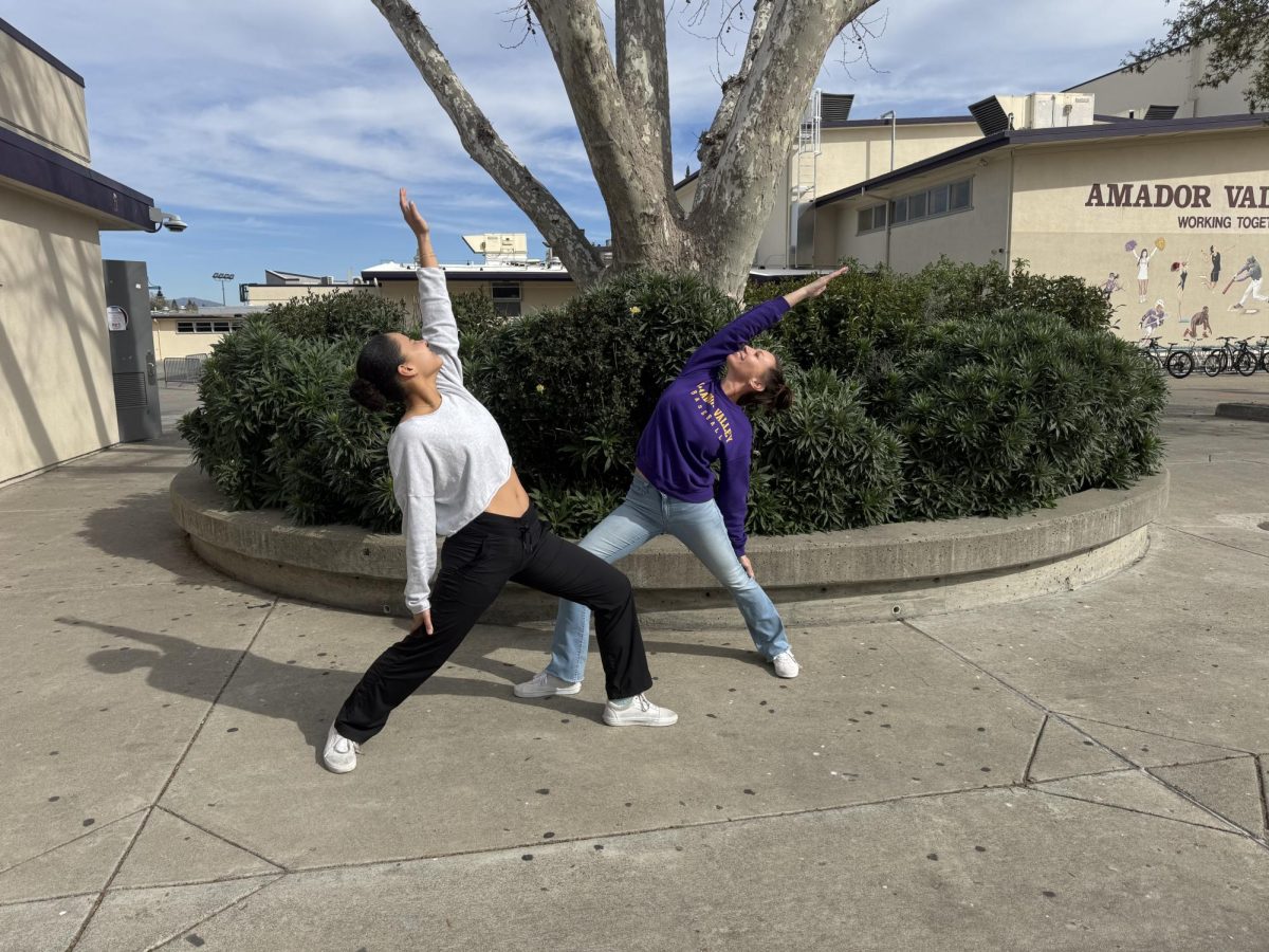 Mrs. Kamali and Abby Jones strike a Reverse Warrior and Warrior 1 pose.